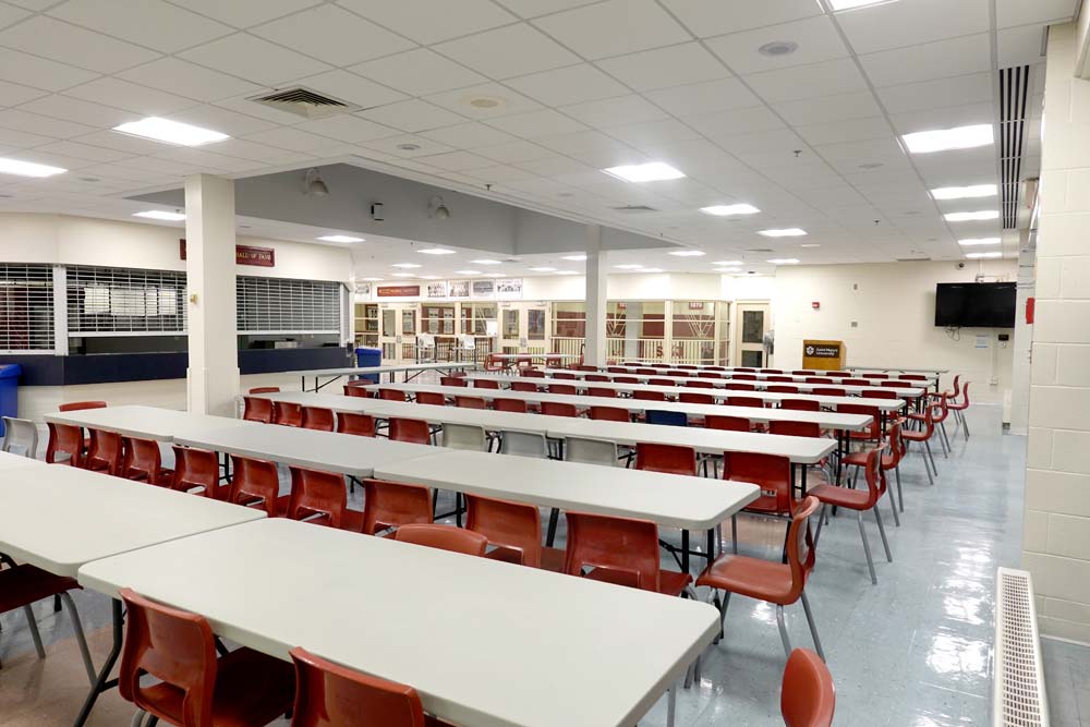 Courtside Lounge with rows of table s and chairs facing a podium