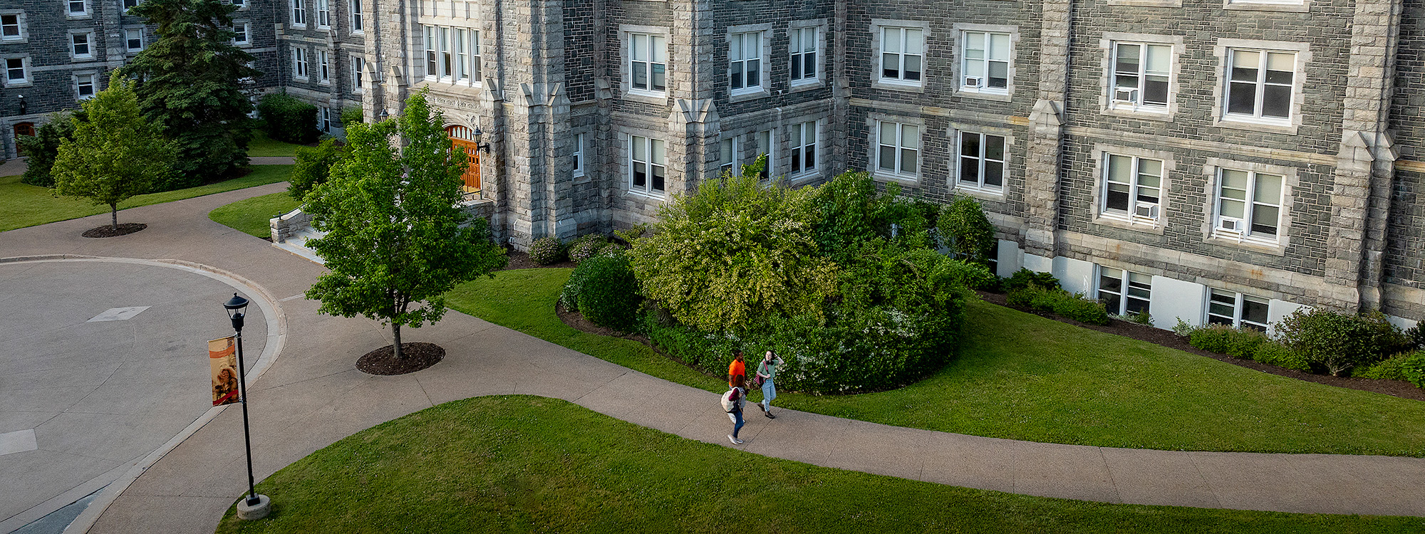 Two students walk past the McNally Building entrance.