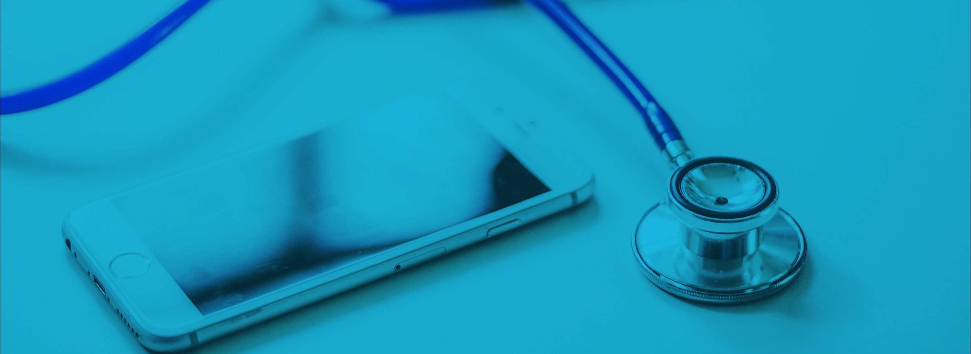 A smart phone beside a stethoscope.